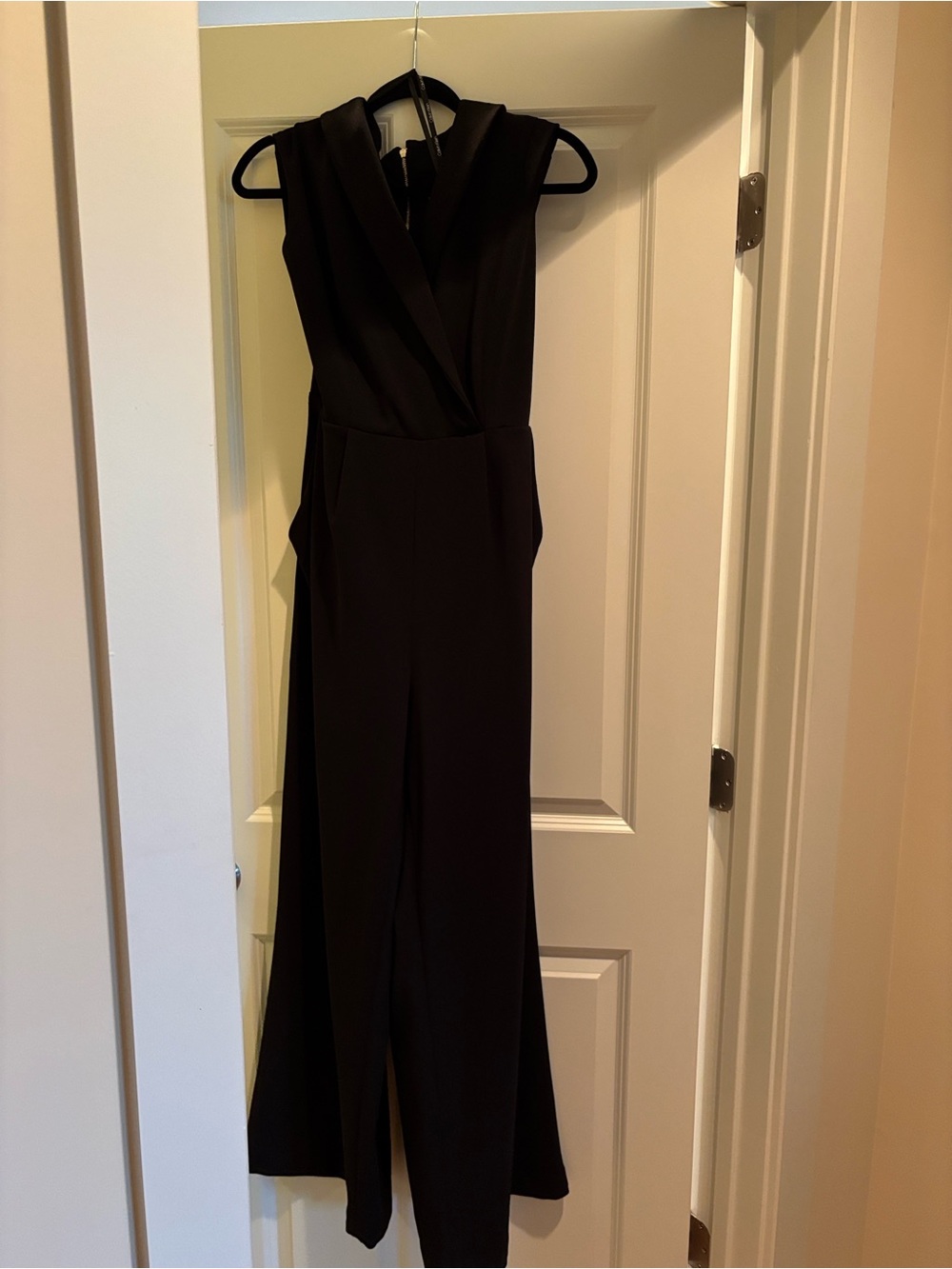 CALVIN KLEIN  Sleeveless Lapel Jumpsuit in black.